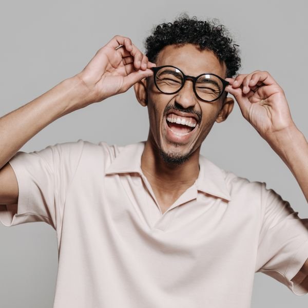 A professional laughing during a conversation at work