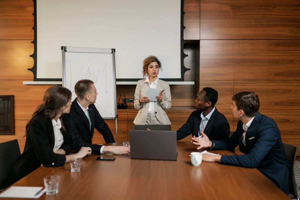 A learning provider talking with team members